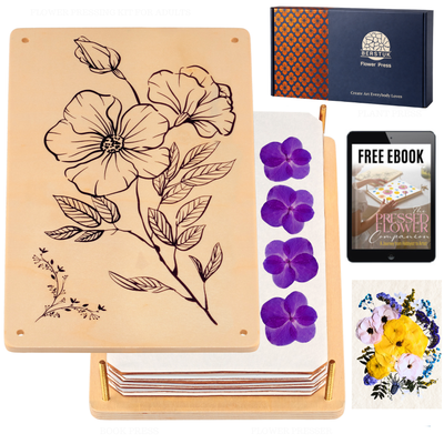 Collection of items including a wooden press, flowers, and a free eBook on a white background