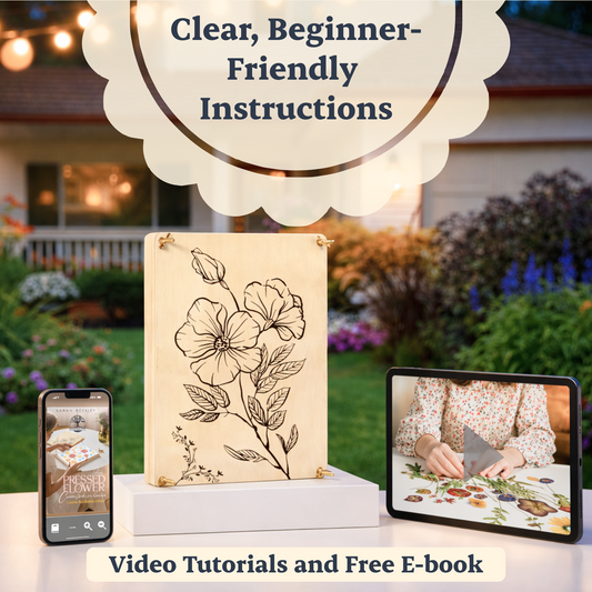 Flower press on a small pedestal on a table with video tutorials on a tablet and free e-book on a mobile phone.