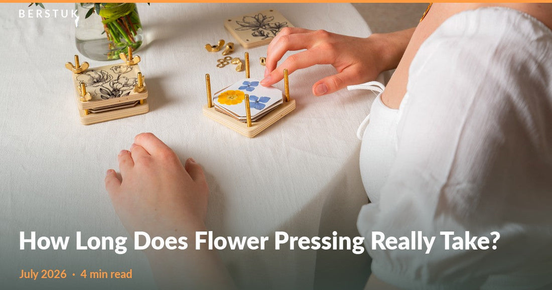 An open Berstuk Miniature Flower Press with yellow and blue pressed flowers beside a closed press and a fresh bouquet