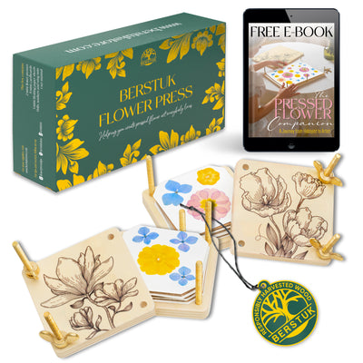 Two wooden mini flower presses with packaging and a tablet showing a free e-book 