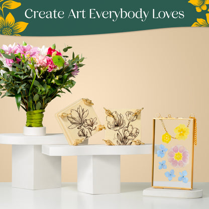 A fresh flower bouquet on one pedestal, two mini flower presses with floral prints on a second pedestal, and pressed flowers displayed in a golden glass frame on a third. Banner text reads 'Create Art Everybody Loves.'