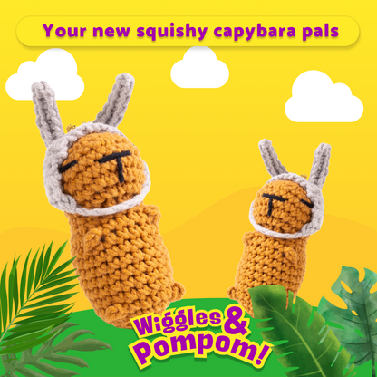 Two crochet capybara toys with bunny ears on a yellow background with green leaves and text.