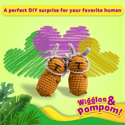 Two brown crochet capybaras with bunny hats on a colorful background with text 'Wiggles & Pompom'.