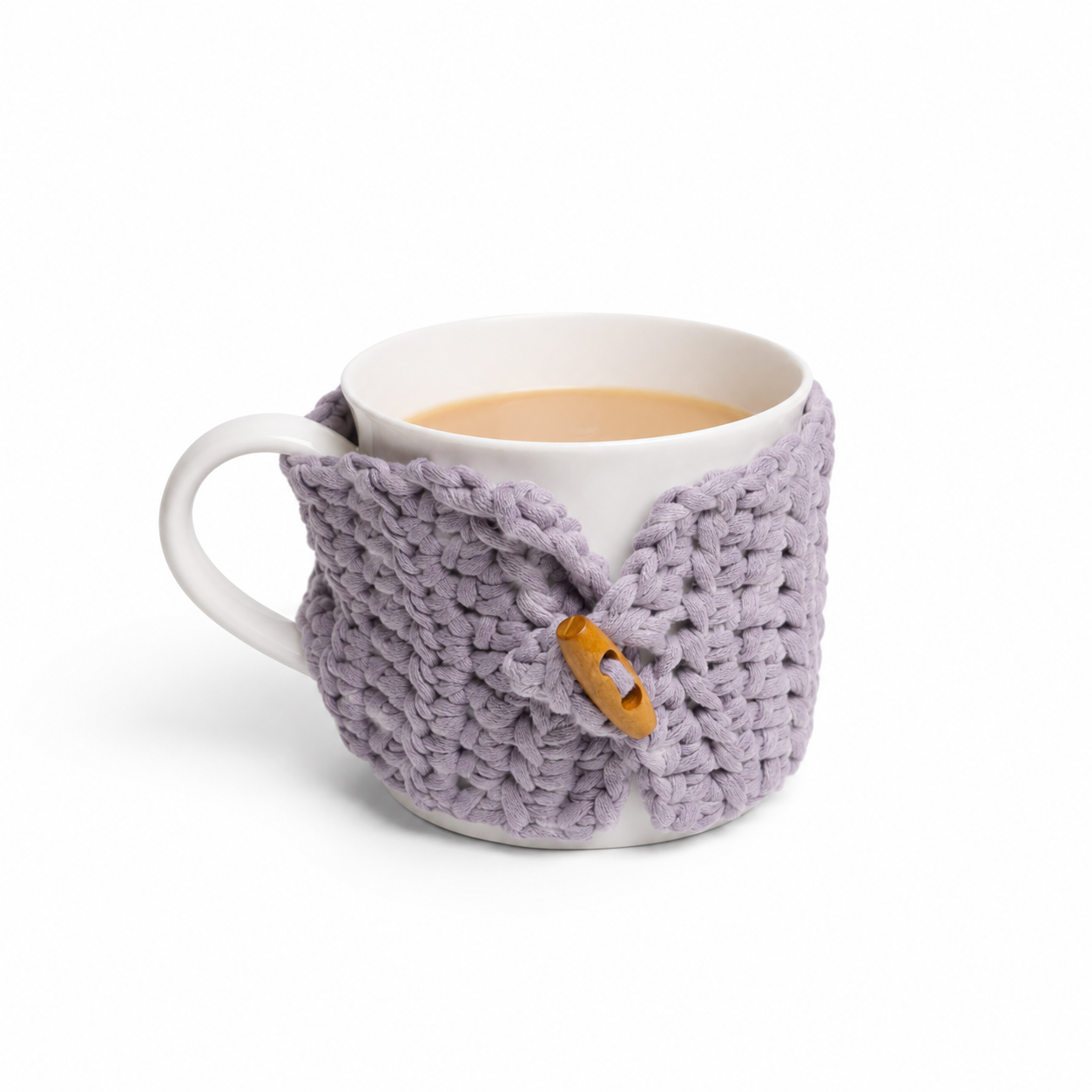 A white ceramic mug filled with tea, wrapped in a chunky grey knit mug warmer featuring a small wooden button closure, on a clean white background.