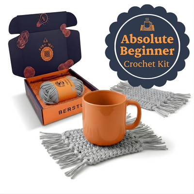 Absolute Beginner Crochet Kit with yarn, mug, and coaster on a white background