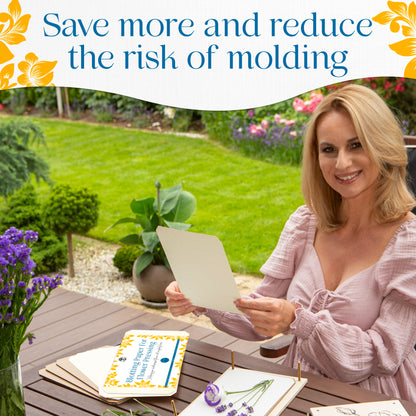 Woman holding blotting paper over a flower press with lavender at an outdoor table
